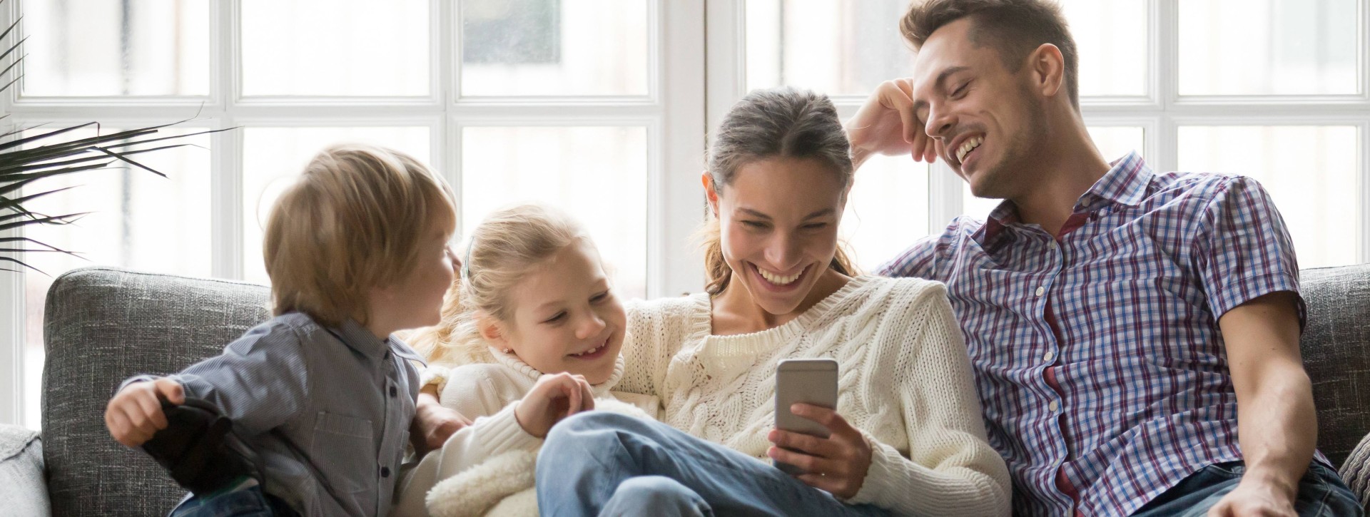 Young family smiling on couch