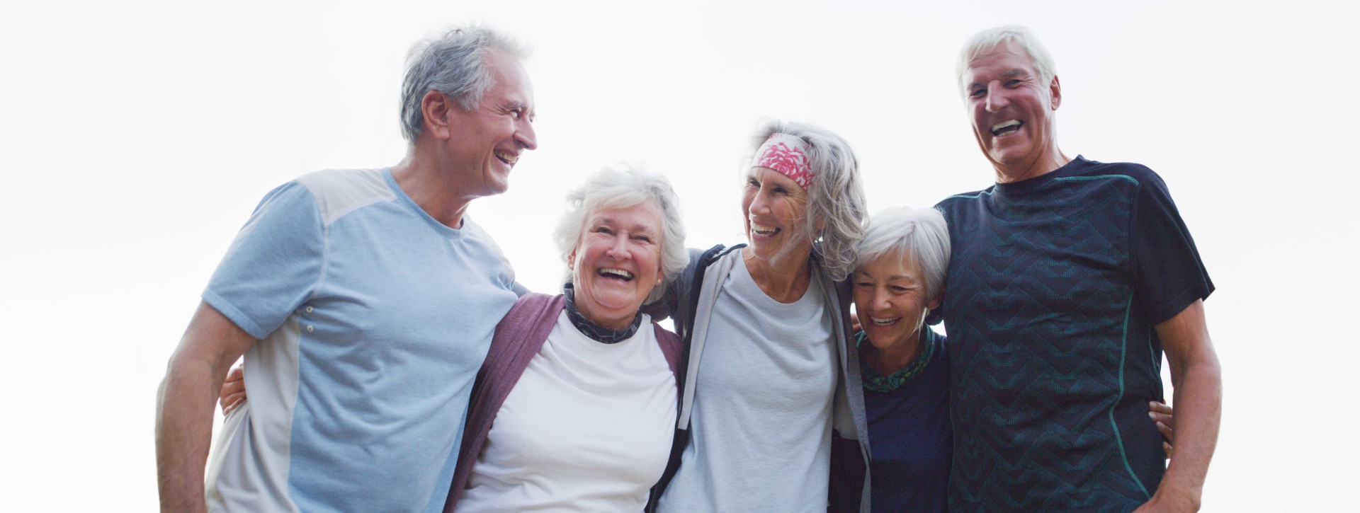 Older group of friends smiling outside